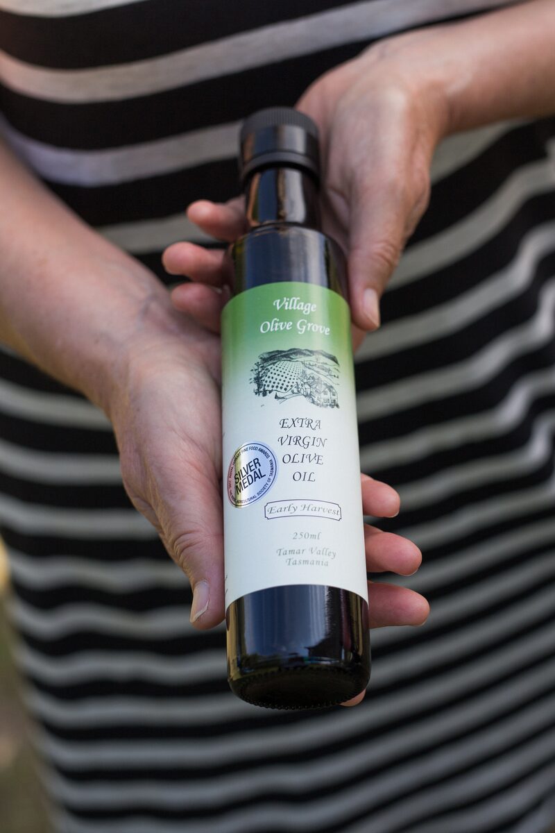 Bottles of Village Olive Grove extra virgin olive oil