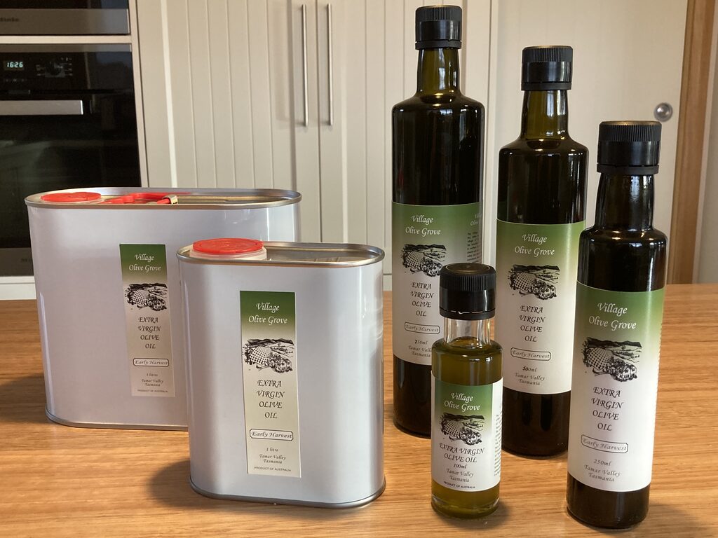 The full range of Village Olive Grove bottles and cans